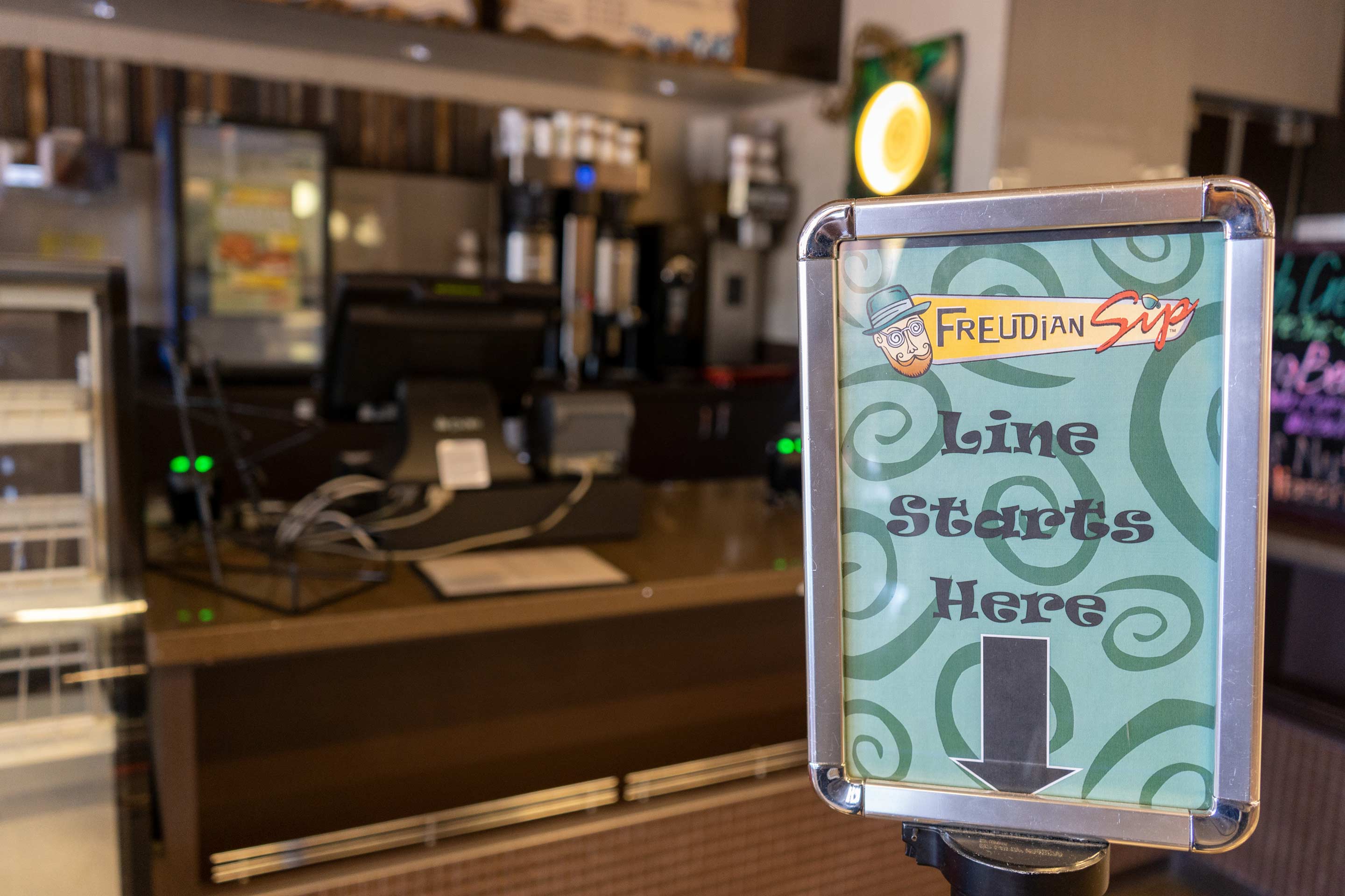 Freudian Sip café counter and service sign.