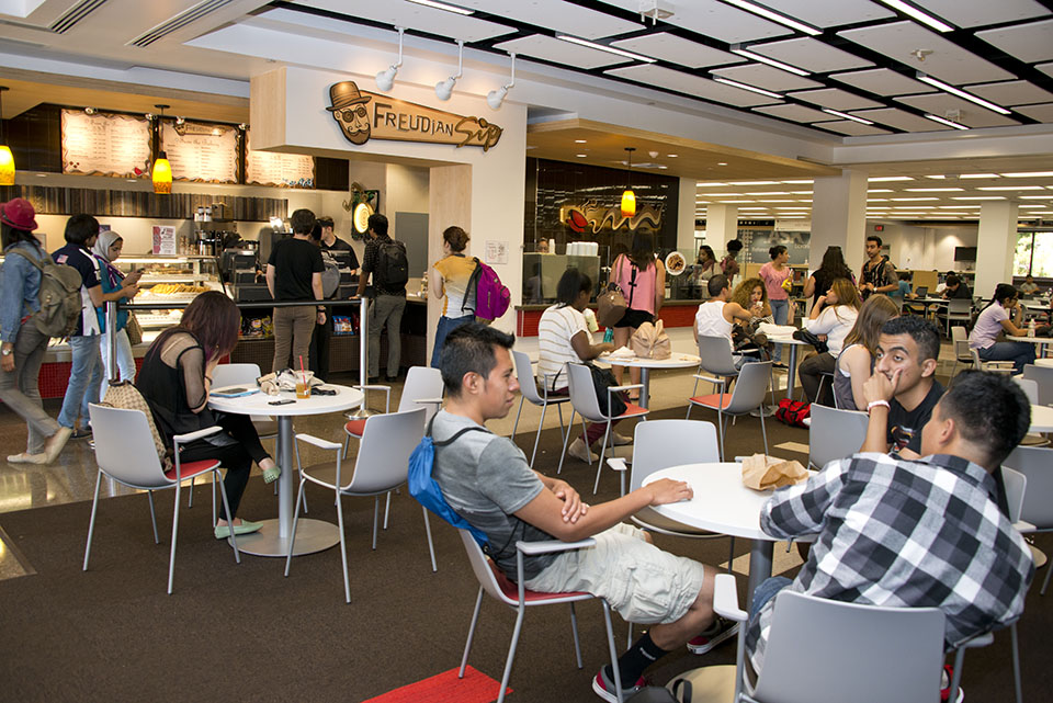 Students using tables in the Library Learning Commons.